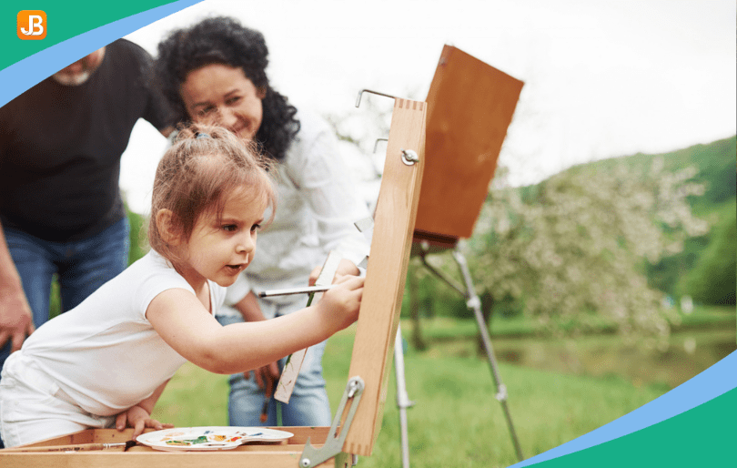 Child painting with colorful paints during an easy-to-set-up art activity