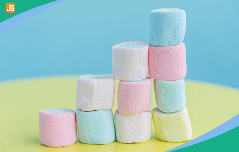 A tower made of marshmallows and toothpicks on a table