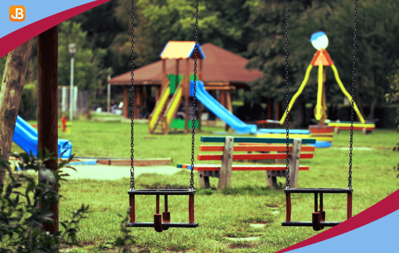 A preschool playground featuring swings, slides, and open areas for active play