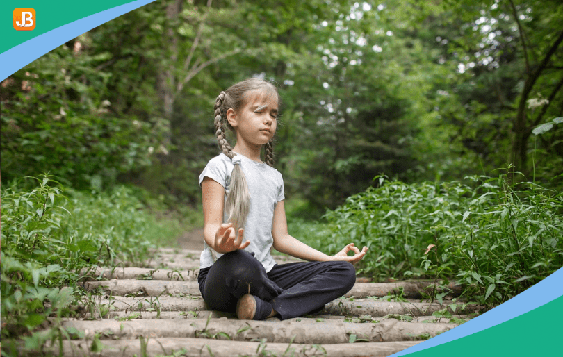 A young girl is practicing a yoga pose outdoors and engaging in mindfulness activities
