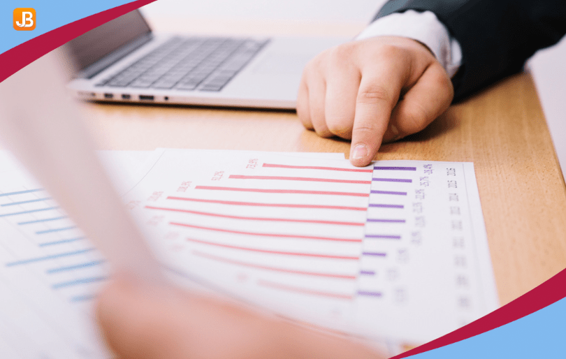 Finger pointing to a document listing risks, symbolizing the process of evaluating and prioritizing risks