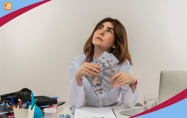 A woman holding cash while thinking, with a laptop in front of her, representing common childcare billing questions.